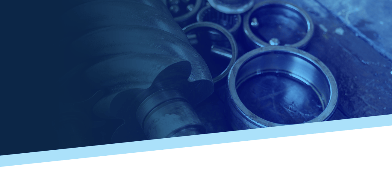 Bearings and a rotary screw airend screw on a table with a heavy blue gradient overlay